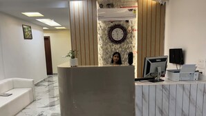 A reception desk with a computer, a clock, and a security camera. -  TRPOTELS THE ANANTA INN Near Old High Court Gwalior (Gwalior)