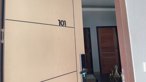 A wooden door with the number 101, a keyhole, and a small keychain. - Marin House Pattaya (Pattaya)