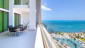 A balcony with a view of the ocean and a pool area. - Garza Blanca Resort and Spa (Punta Sam)
