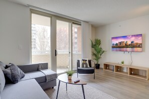 Comfort Apartment, 2 Bedrooms, City View | Living area | 50-inch Smart TV with cable channels, fireplace