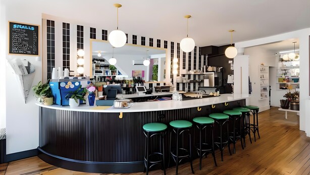 A modern bar area with a counter, stools, and hanging lights. - West End Bright Spot with Parking. (Portland)