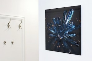 A wall-mounted artwork depicting a crystalline structure with light reflections. - Apartment Donat  (Zadar)
