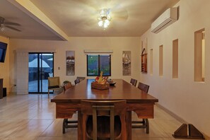 Enjoy meals in this dining area with a long table and comfortable chairs.