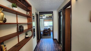 A hallway with wooden shelves, a dark wood floor, and a sign reading "Enter As Strangers - Leave As Friends". - 2 Cabins on 4 private acres! Sleeps up to 12, with options for more, if camping! (Lava Hot Springs)