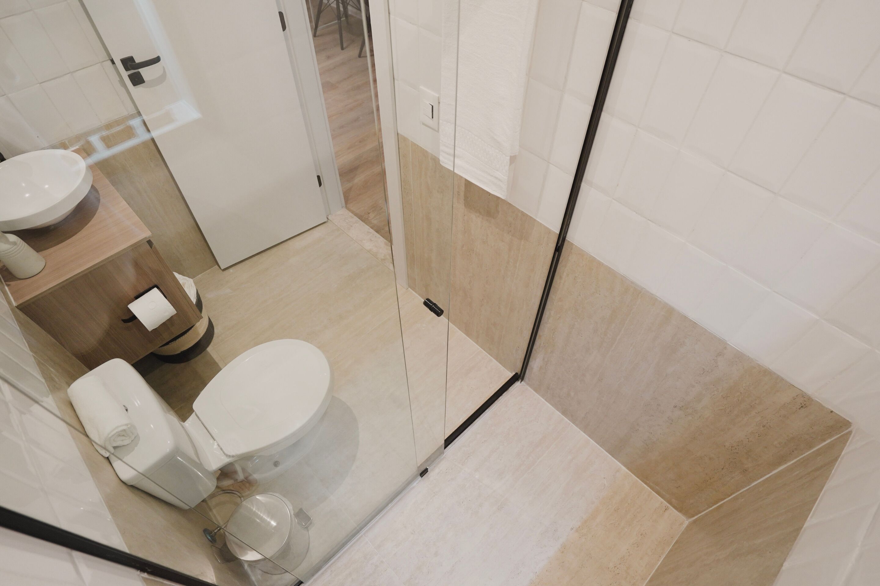 A modern bathroom with a toilet, sink, and shower area.