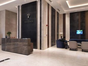 Guests can relax in the comfortable waiting area, featuring a sofa and armchairs.