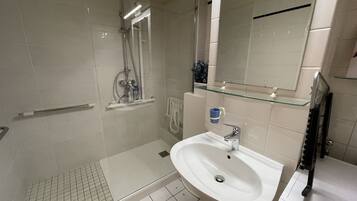 Shower, hair dryer, towels, toilet paper