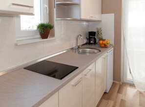 Fridge, stovetop, coffee/tea maker, cookware/dishes/utensils
