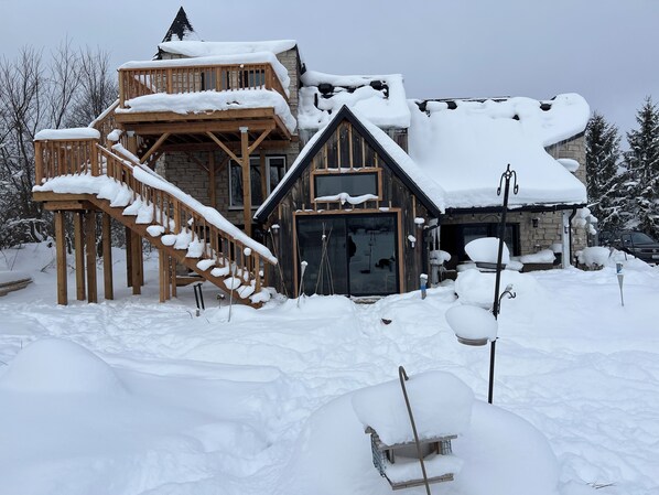 Step into a serene winter wonderland from the comfort of this cabin's spacious deck.