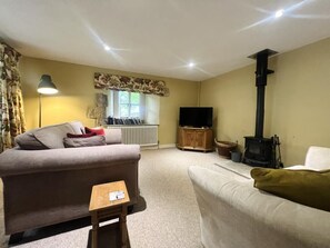 Relax in this inviting living room with a comfortable sofa, coffee table, and fireplace.
