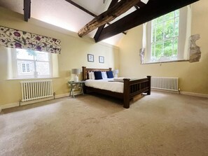 Cozy retreat with a single bed, sloped ceiling, and traditional charm.