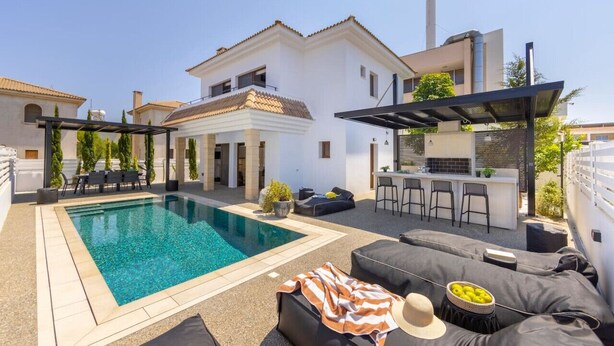 A pool area with a bar and outdoor seating. - SunnyVillas: 3BR New Modern Villa*Private Pool*HVN (Paralimni)