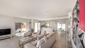 A modern living room with a sofa set, a coffee table, and a flat-screen TV. - SunnyVillas: 3BR New Modern Villa*Private Pool*BLG (Paralimni)