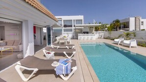 A modern hotel with a pool area, sun loungers, and a bar. - SunnyVillas: 3BR New Modern Villa*Private Pool*BLG (Paralimni)
