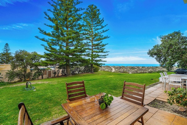 Outdoor alfresco dining area with stunning sea views.