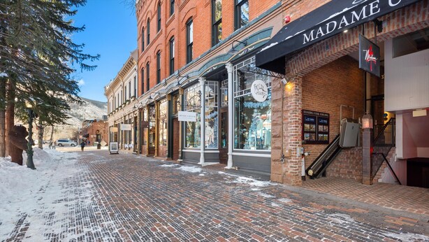 A brick-paved street with storefronts, including a visible sign for 'Madame O' and a sign for 'Rice-O-Rice'. - 2-Bedroom Top Floor View Condo in Downtown Aspen (Aspen)