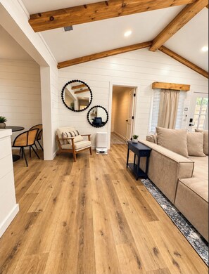 Bright modern-rustic living room with vaulted ceilings and wood beams