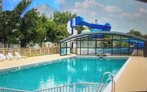 A swimming pool with a water slide, lounge chairs, and a covered seating area. - Louisiana, 6 people   (La Boissière-de-Montaigu)