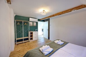 A bedroom with a bed, a wardrobe, and a mirror. - Charming half-timbered apartment with modern comfort, 110 sqm (Eltville am Rhein)