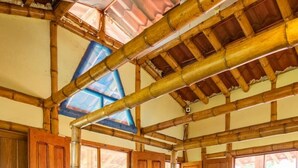 A room with a bed, wooden walls, and a tiled floor. - Seaside Escape | Entire House | Pool Access (Manzanillo)