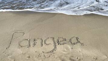 A beach with the word "Paradise" written in the sand.