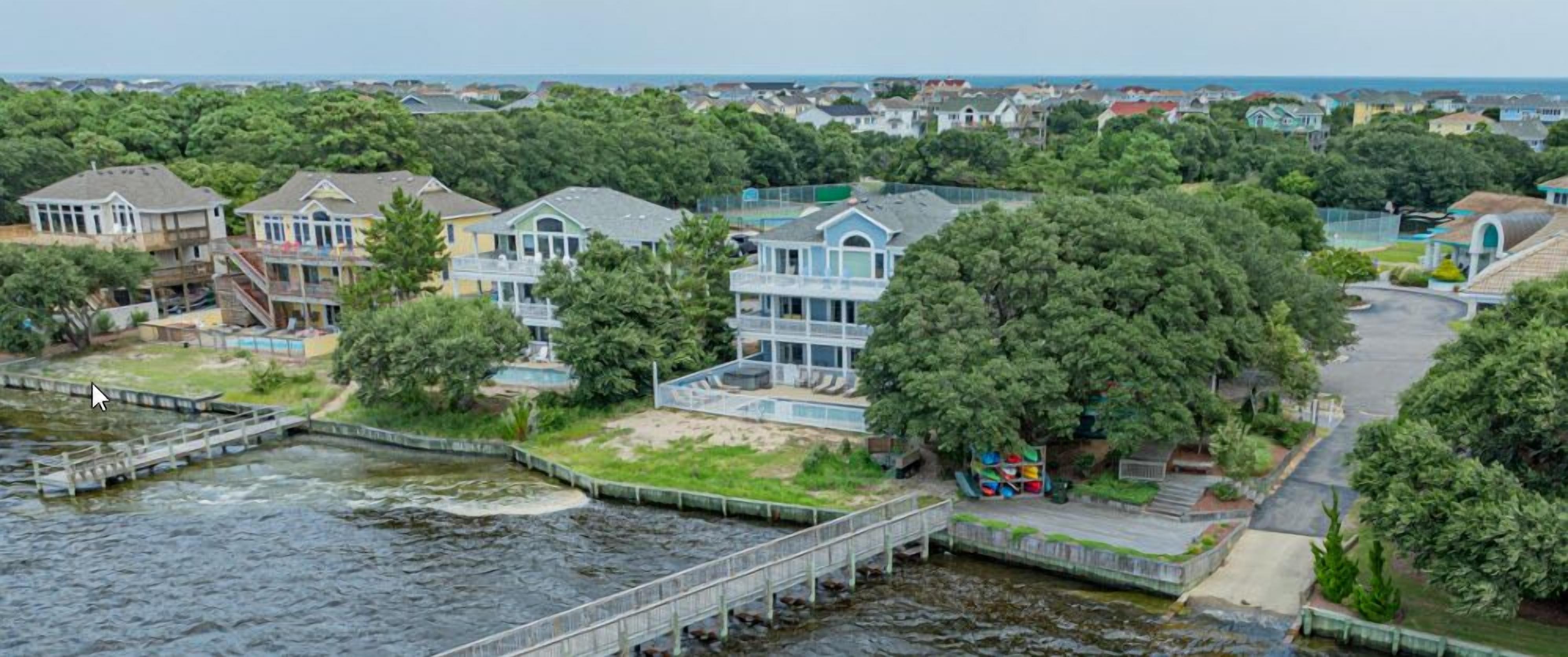 A residential area with houses, a dock, and a river.