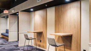 A modern hotel lobby with a check-in counter, seating area, and a visible exit sign. - 2Bedroom, Near Over theRhine & Fountain Sq. + wifi (Cincinnati)
