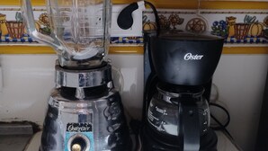 A kitchen with a blender and a coffee maker on the counter. - Brown 101 rest house (Villavicencio)
