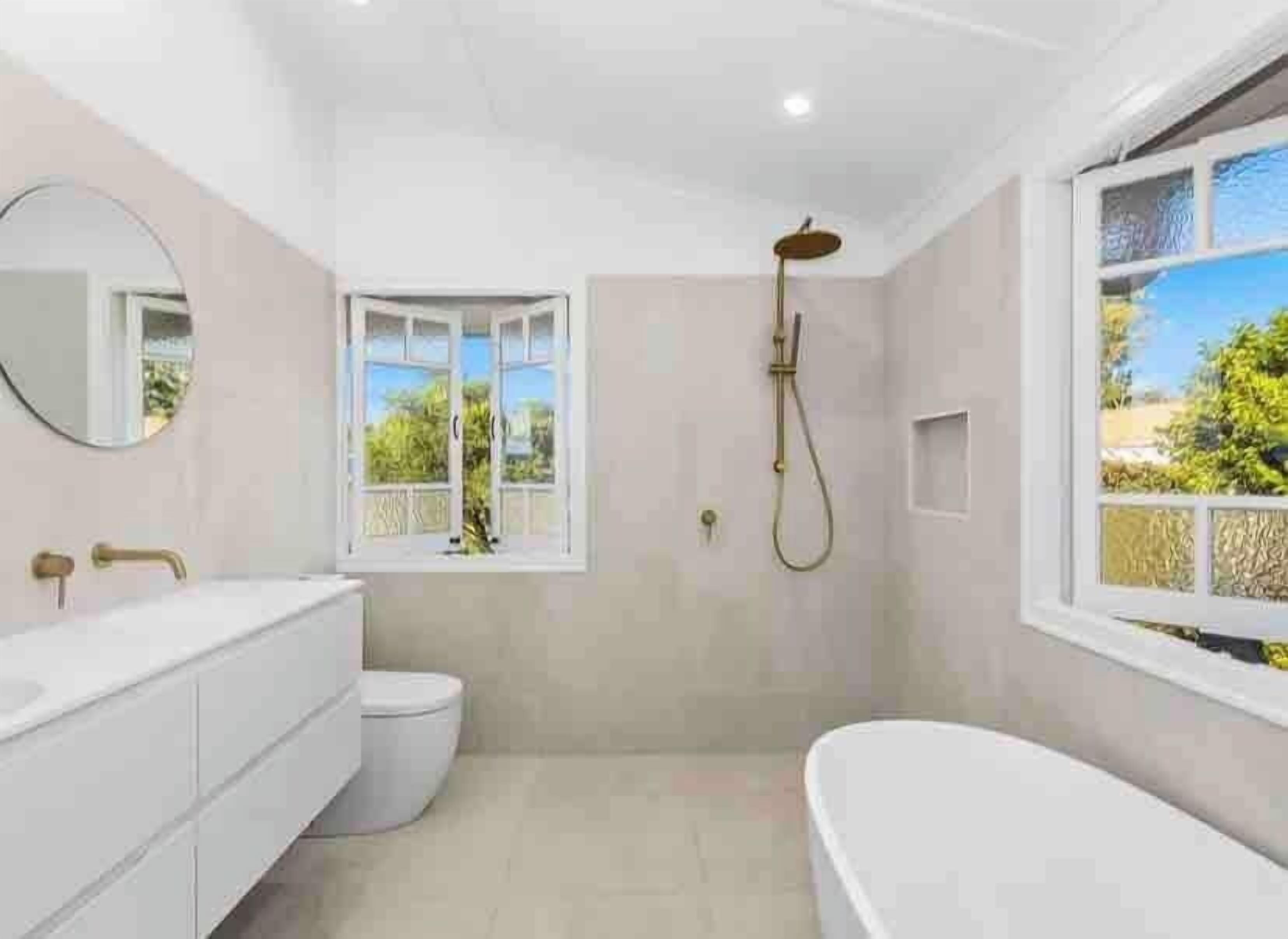 A modern bathroom with a freestanding bathtub, a toilet, and a shower.