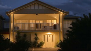 A two-story house with a balcony and a front door. - Urban Getaway Top Floor - 4BR/4BA, Sauna, Ipswich (Newtown)
