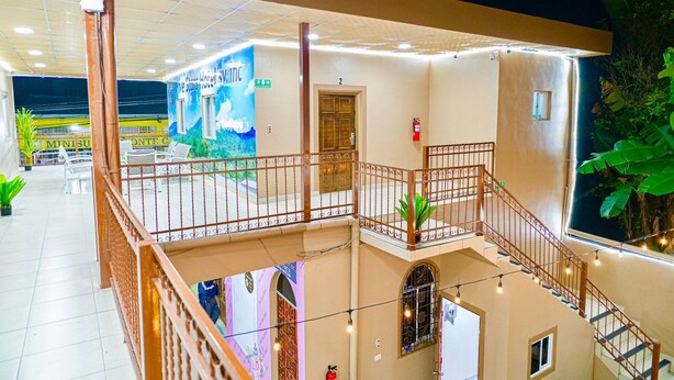 A hotel with a balcony, a mural, and a staircase. - Hotel Five Stars sv (Berlin)