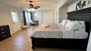 A bedroom with a bed, a desk, and a chair. - Ocean View Beach House. Sleeps 8 Coastal Luxe. Seabreeze! (Norfolk)