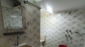 A bathroom with a sink, toilet, and shower.