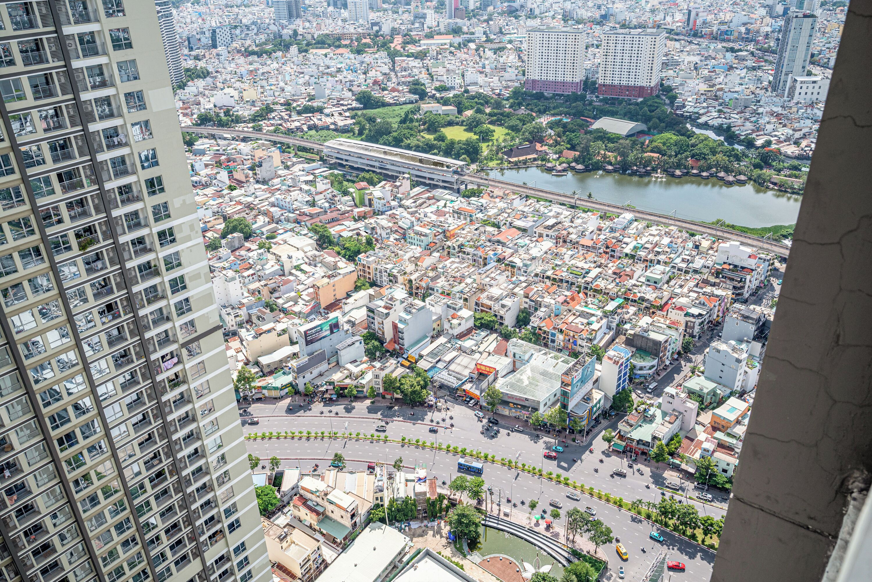 A high-rise building with a view of a cityscape, including a river and a bridge.