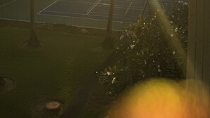 A sunset view with palm trees and a tennis court. - Central AC Ocean & Mountain View 2-bedroom 2-Bath condo across Magic Sands Beach (Kailua-Kona)