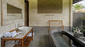 A modern bathroom with a large sink, a freestanding bathtub, and a wooden vanity. - Monique Ubud Villa (Ubud)