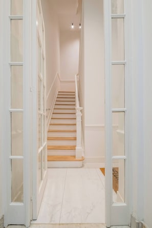 Classic design staircase leads to a bright and inviting space.