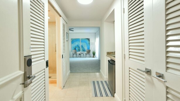 A hallway leading to a dining area with a painting on the wall. - W Hotel SOUTH BEACH 1B RESIDENCE w/OCEAN VIEW - 909 (Key Biscayne Miami)