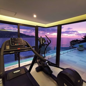 Work out with a view of the serene body of water and distant hills.