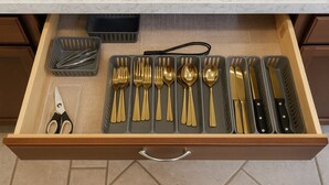 A drawer with neatly organized kitchen utensils including forks, spoons, and knives. - Spacious 4-bedroom house with hot tub and spa-like backyard. Home away from home (Oceanside)