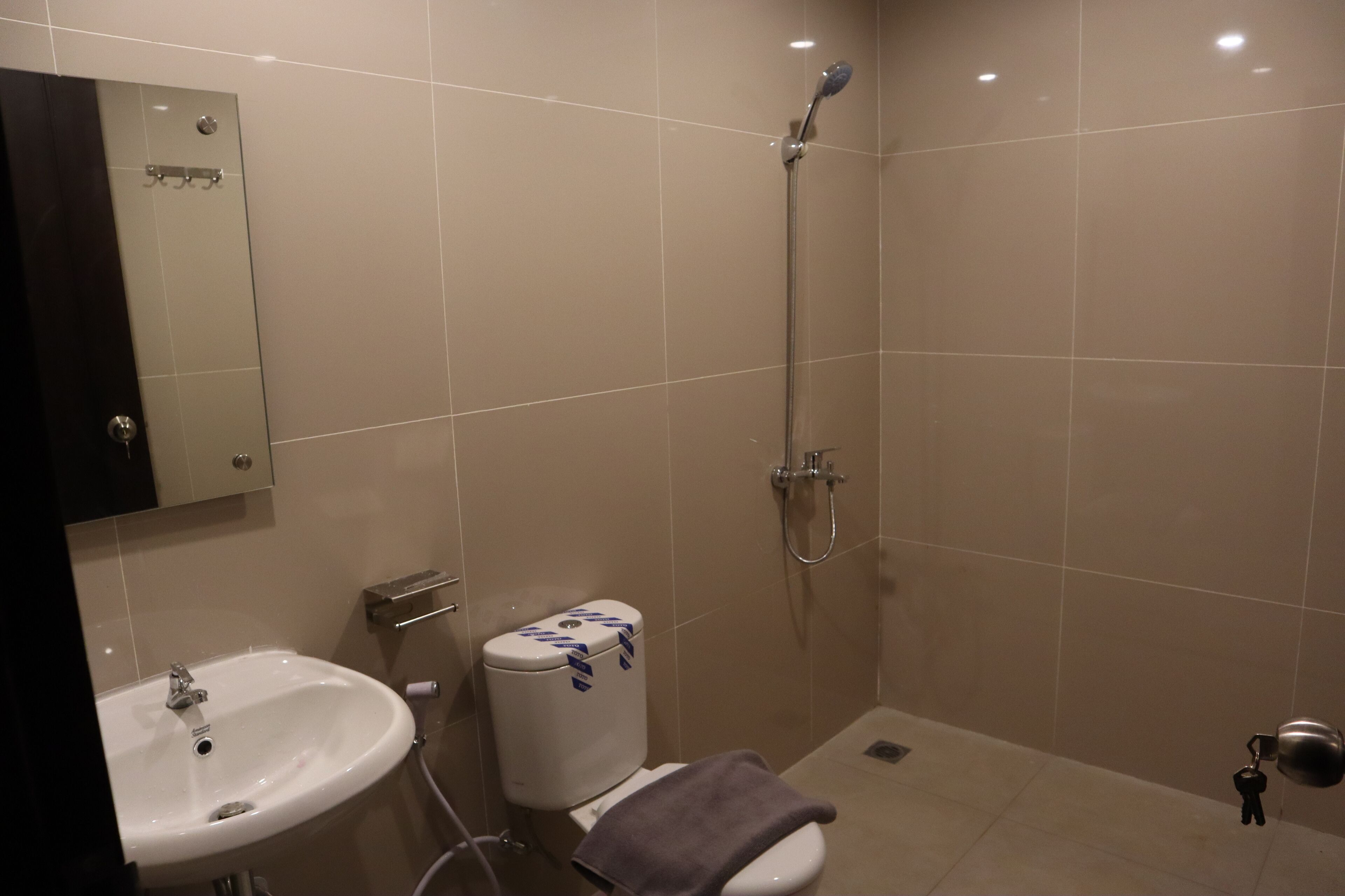 A bathroom with a sink, toilet, and shower.