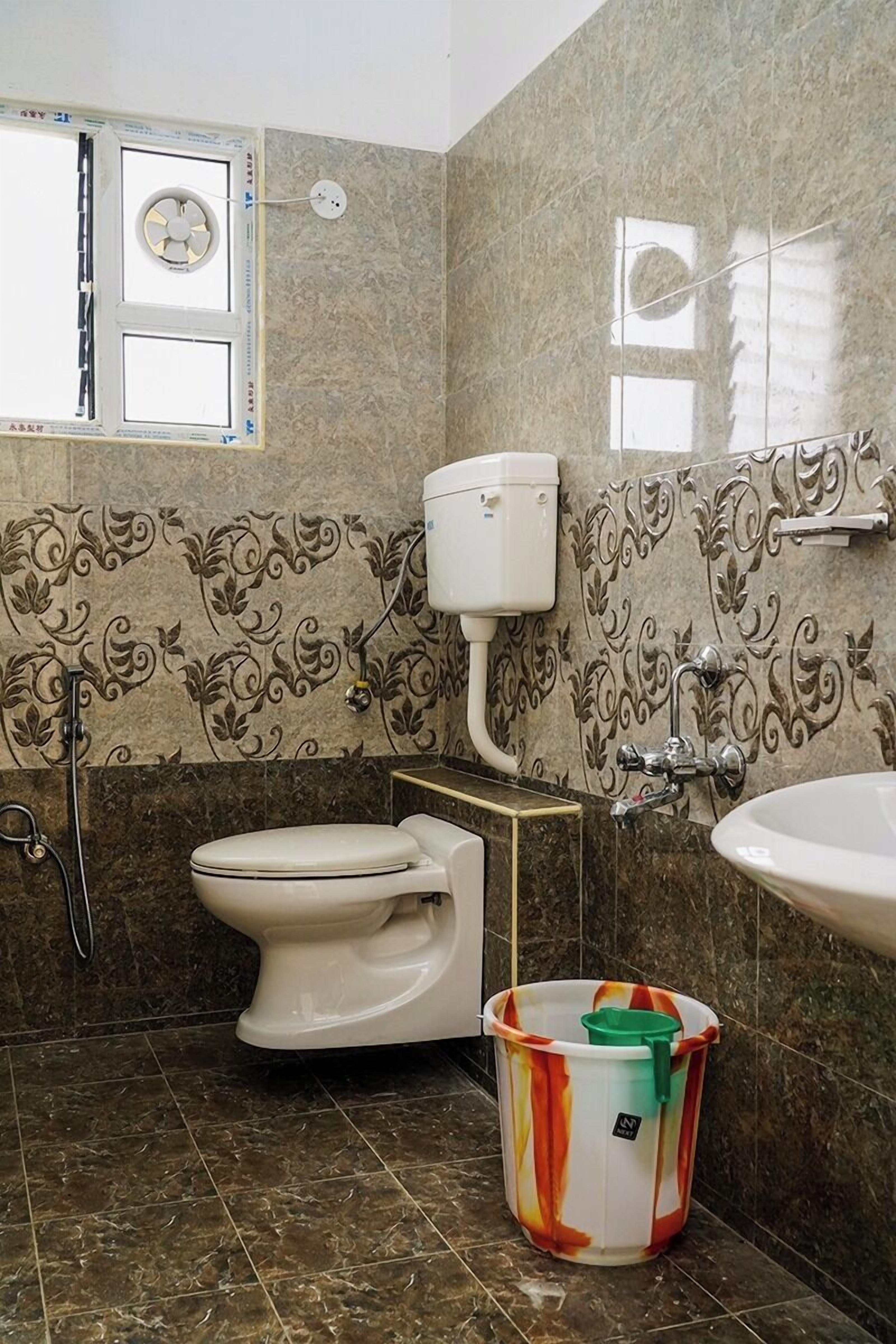 A bathroom with a toilet, sink, and shower.