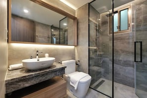 A modern bathroom with a marble vanity, a large mirror, a glass shower enclosure, and a toilet. - Luxury Apartment in Phu My Hung (Ho Chi Minh City)