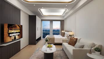 A modern hotel room with a piano, a large bed, a sofa, a coffee table, and a city view.