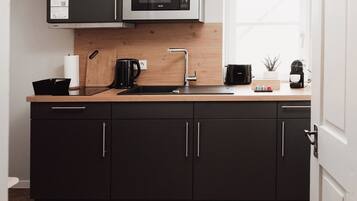 Fridge, microwave, stovetop, coffee/tea maker