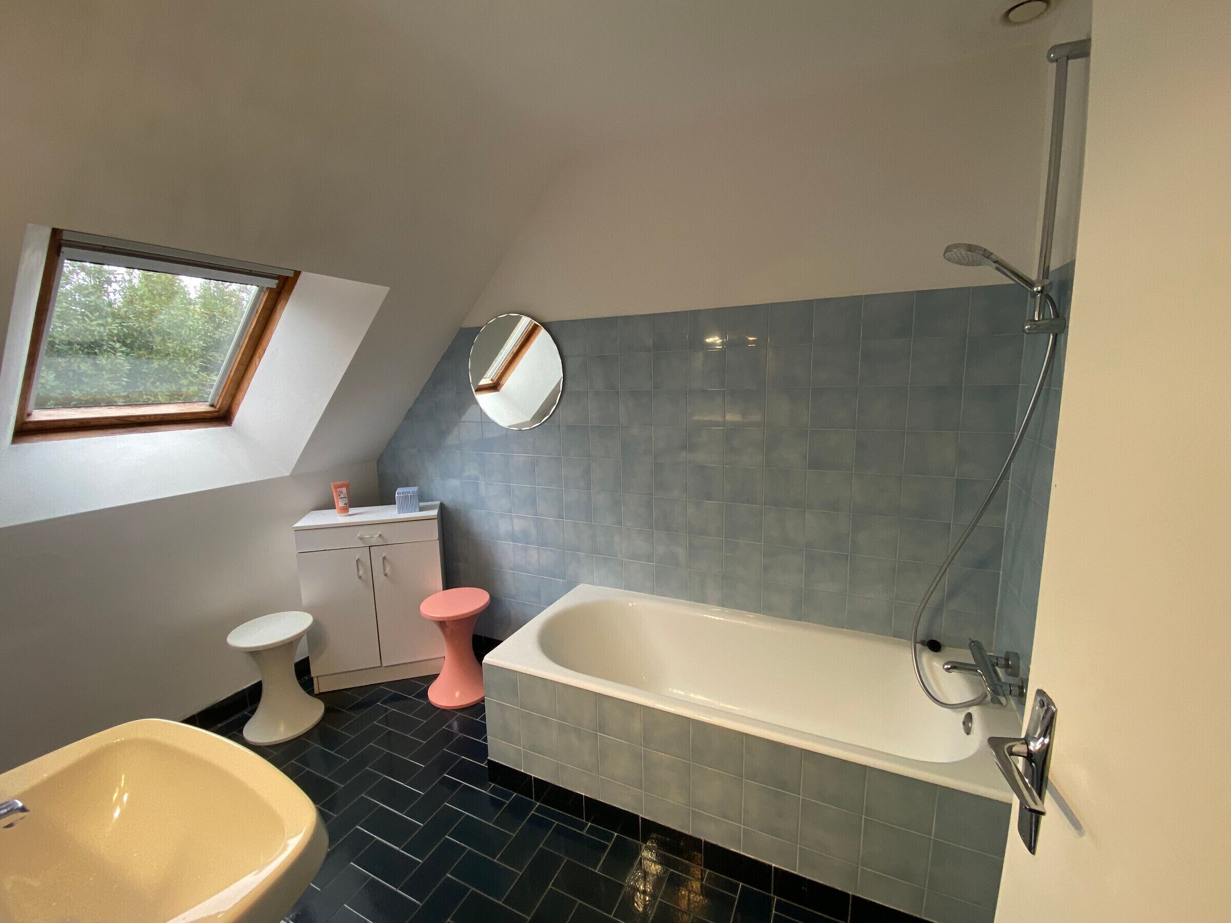 A bathroom with a bathtub, a sink, a toilet, and a vanity.