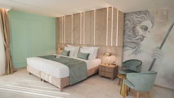 A modern bedroom with a bed, bedside tables, a chair, and a wall mural.