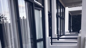 A modern interior with large windows, a staircase, and a clean, minimalist design. - Monarch Ella (Ella)