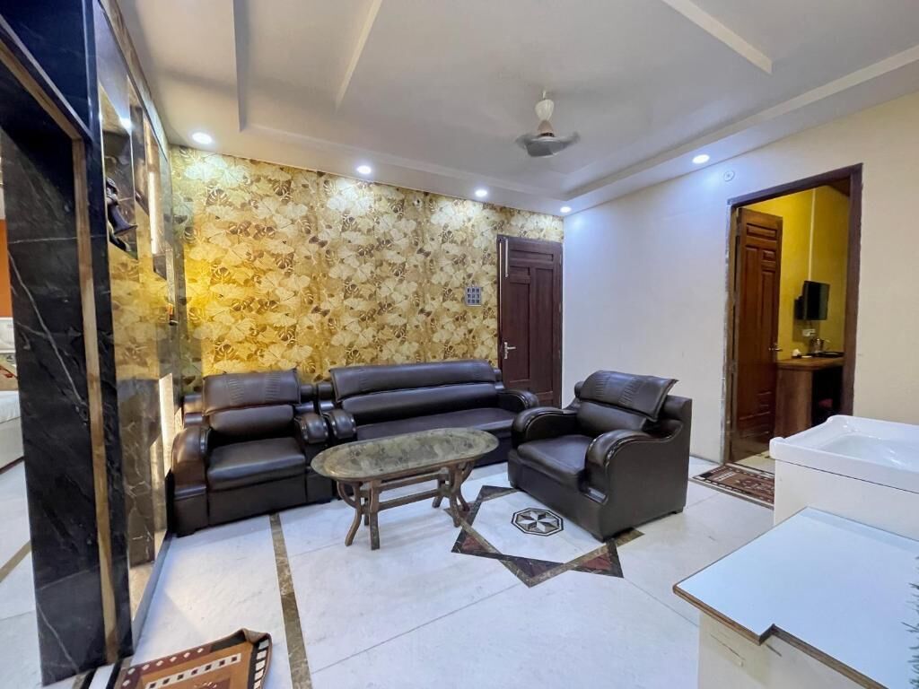 A living room with a sectional sofa, a coffee table, and a white cabinet.