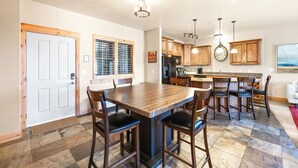 A spacious kitchen with a central island, wooden cabinets, and a large clock on the wall. - Luxury Townhome, Private Balcony, Great Location, 3 Bedrooms, Hot Tub! (Park City)